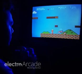 Close-up of a person playing a retro arcade game on a monitor.