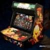 Compact arcade gaming machine with vibrant character artwork and multiple game options.
