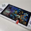 Handheld gaming console displaying Crossmix OS setup with custom upgrade card.
