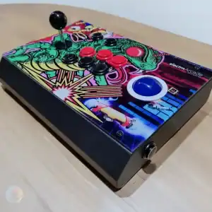 Arcade Fightstick with trackball and colorful retro design for gaming enthusiasts.